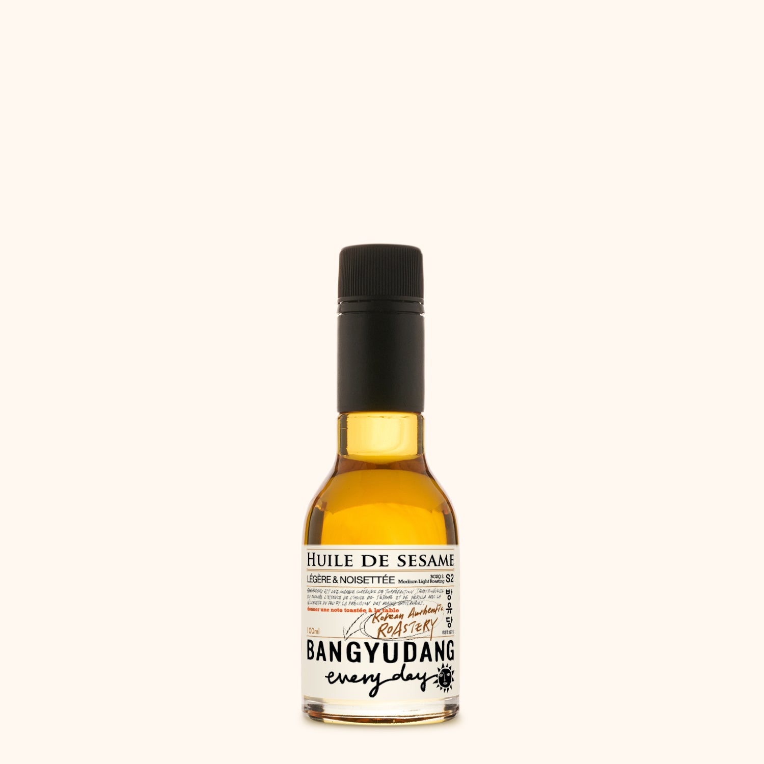 Bouteille de 100ml d'huile de sésame douce Bangyudang S2, fond clair, étiquette beige dorée et typographie noire.

